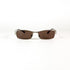 Vue de face d’une paire de lunettes Yves Saint Laurent 2080/S en métal brossé avec verres bruns sur fond blanc