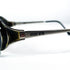 Lunettes Dolce Vita DVS-11 vues de biais, posées à plat, mettant en valeur le contraste entre les matériaux et la forme ovale