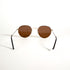 Détail de la branche fine en métal doré des lunettes vintage Morel avec plaquage or