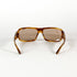 vue de dos, monture épaisse écaille miel et verres solaires marron, design industriel des années 1990