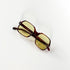Lunettes de soleil vintage Jean Lempereur 114, modèle écaille aux verres jaunes, posées face vers le bas